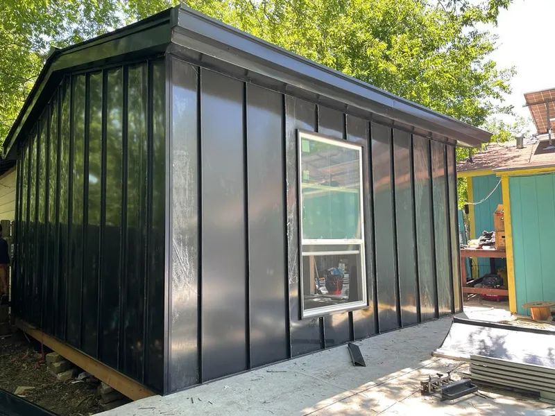 Black standing seam metal wall panels for Roof Inspection in North Kingstown