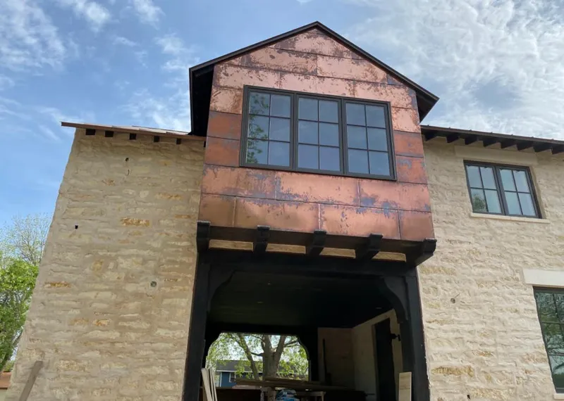 Copper metal panel facade on a stone building for Skylight Installation in North Kingstown